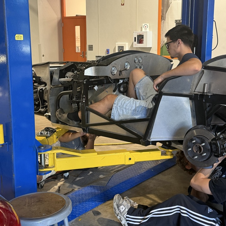 students working on the kit car