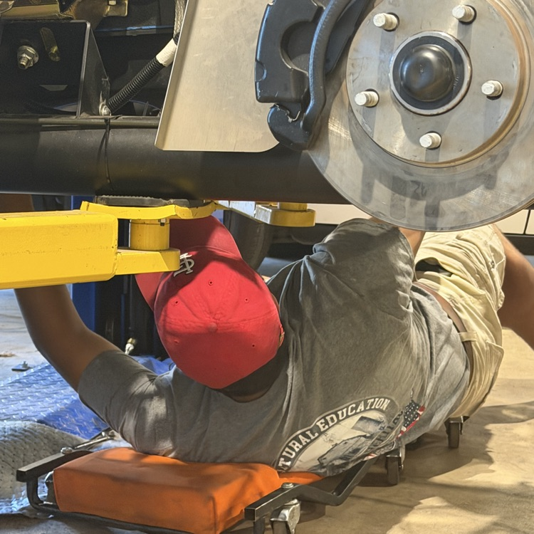 students working on the kids car