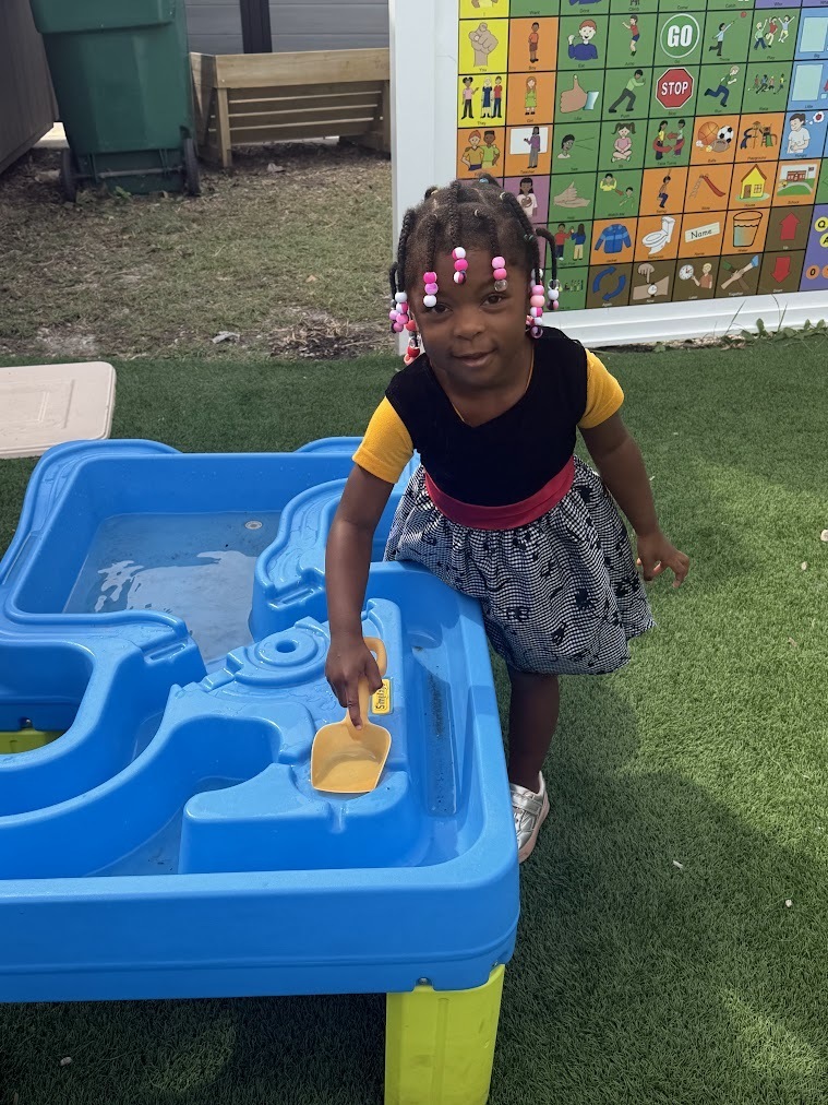 student playing at the water table 