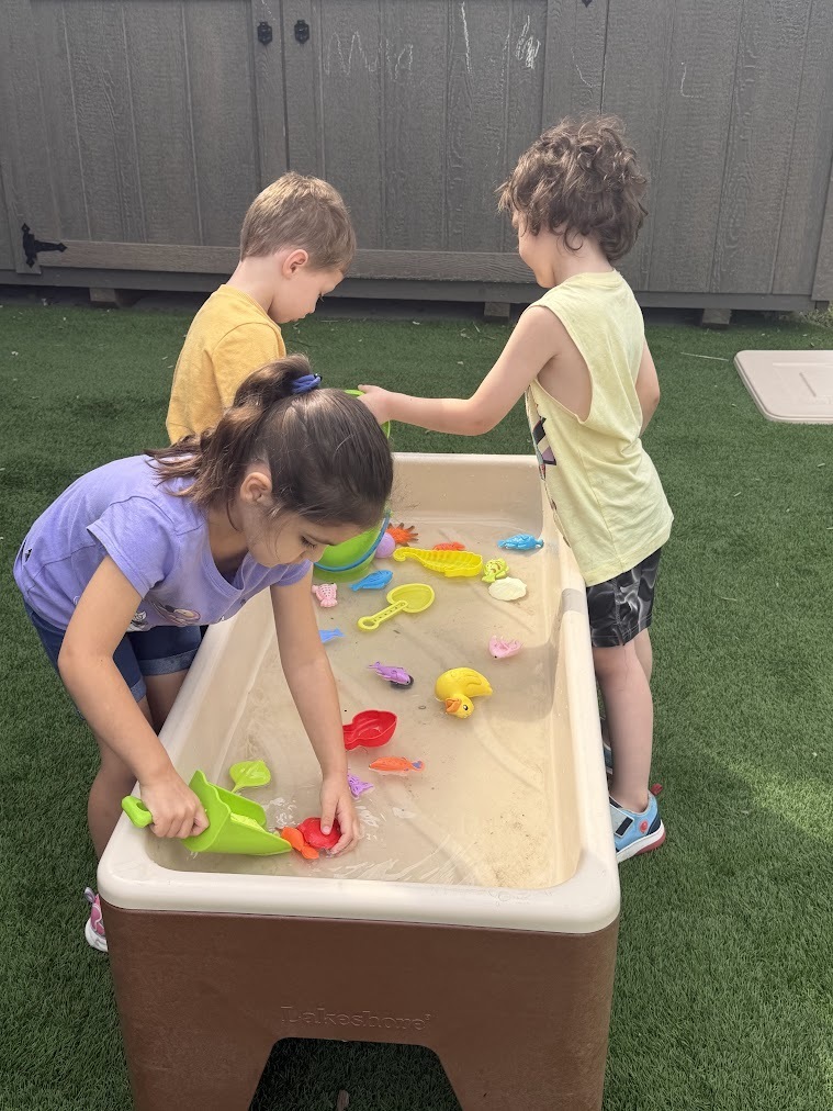 students playing in sand table 