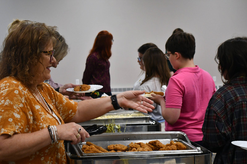 Teacher serving student food 