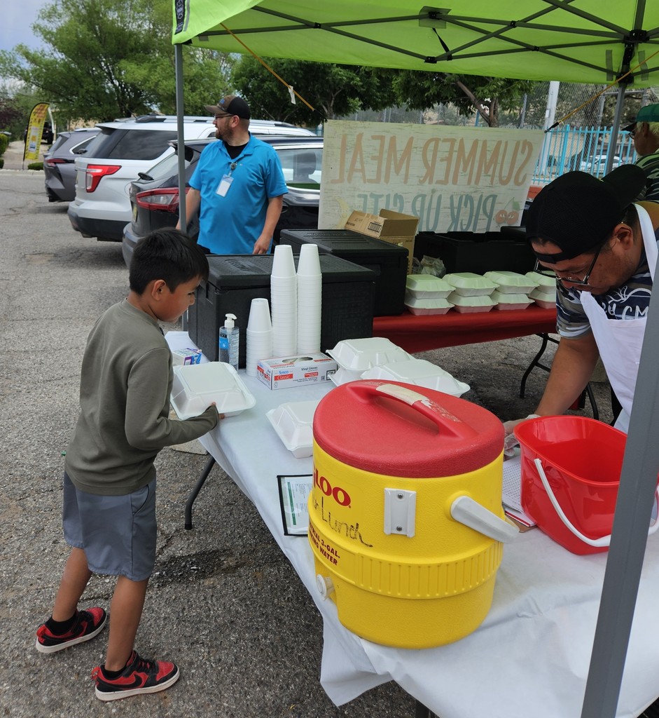 SFE staff feeding students