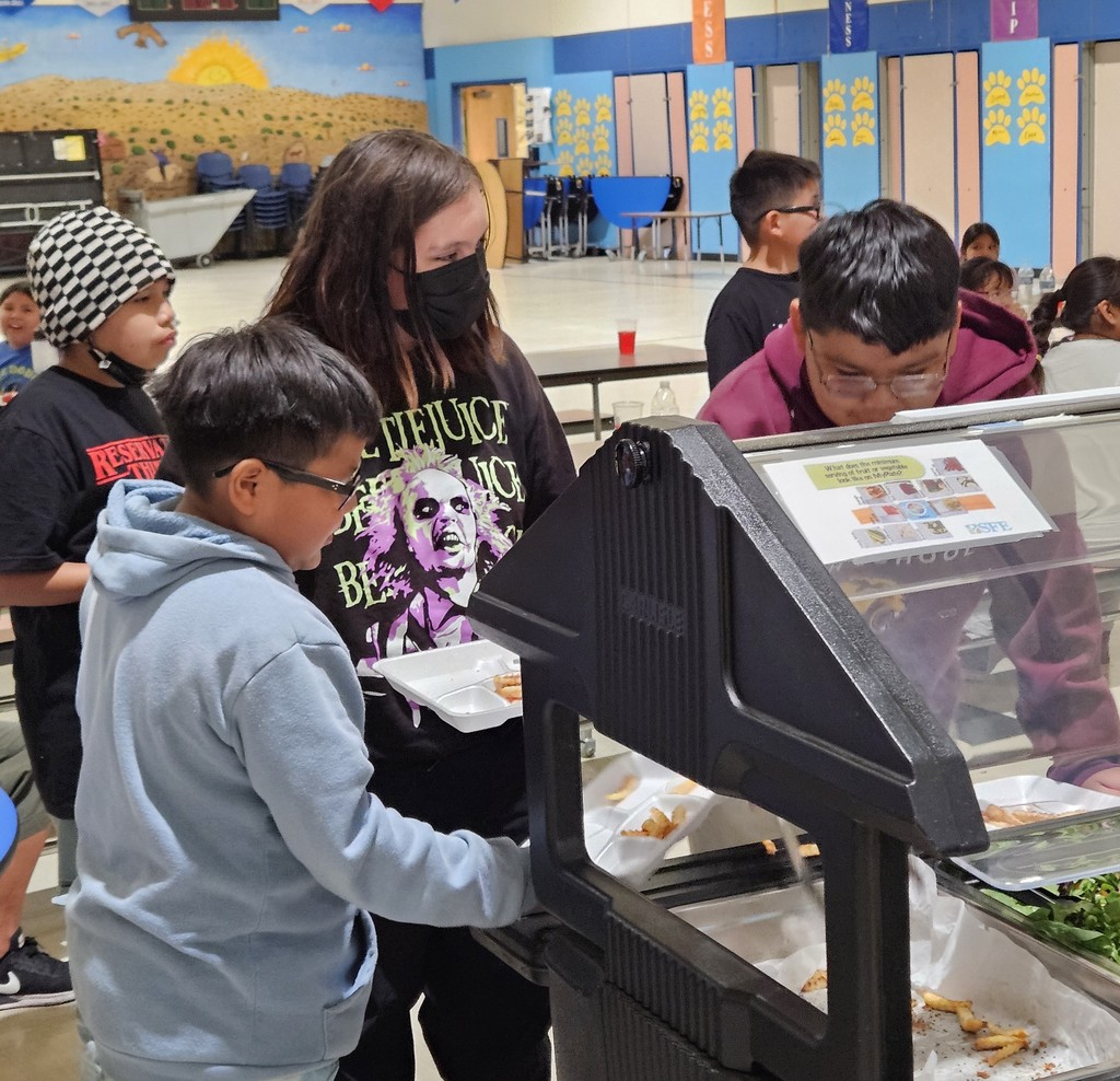 SFE staff feeding students