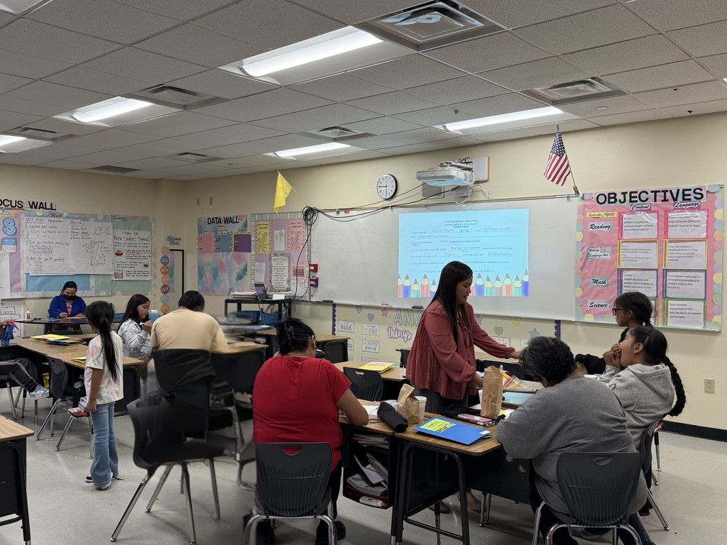 Mrs. Ferreras our 4th grade teacher walking around talking with families about the activity they can do with their students at home.