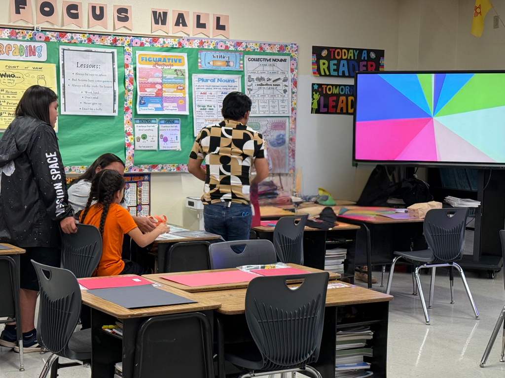 Mr. Pascua our second/ third split teacher working with a family on an activity to help their student  learn in math. 