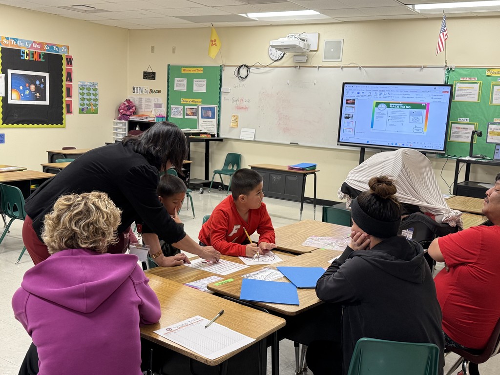 Ms.. Larena one of our first grade teachers and Mrs. Bowker our PE teacher doing the race to 50 activity with a family. 