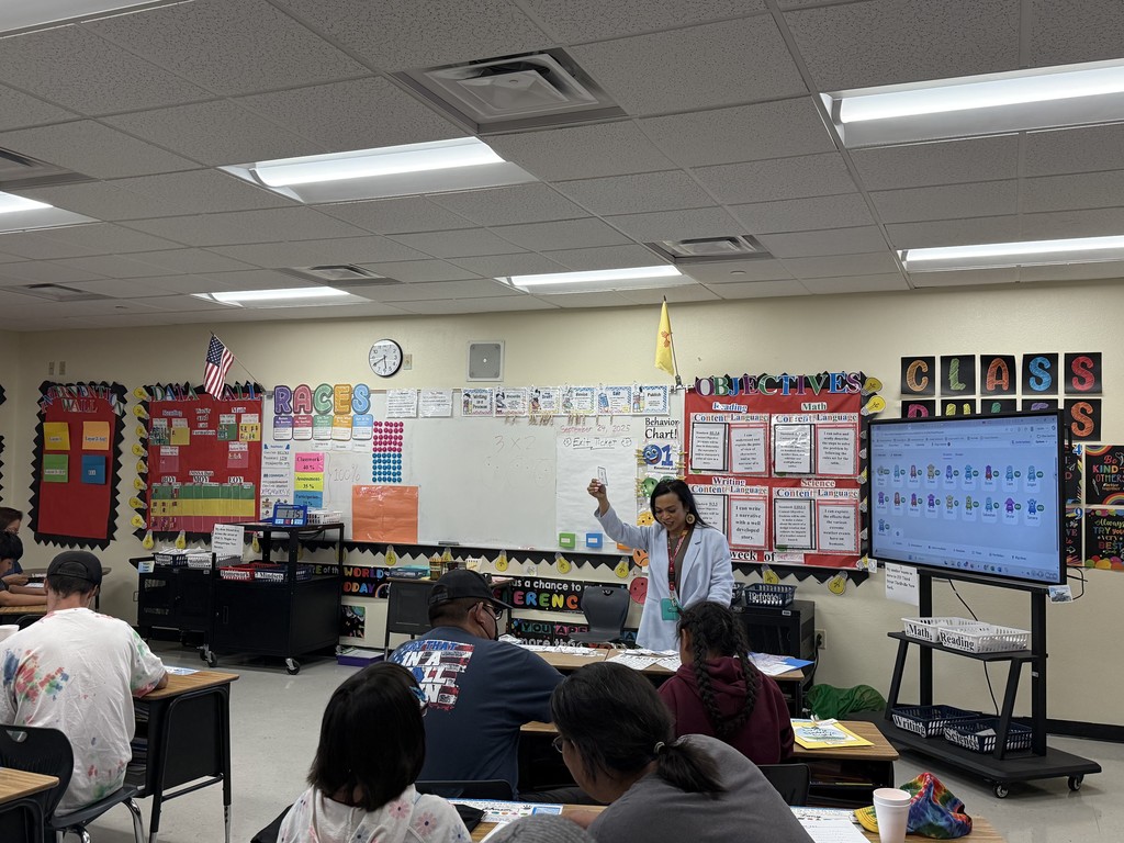 Ms. Westover explaining the game to the parents, families and students.