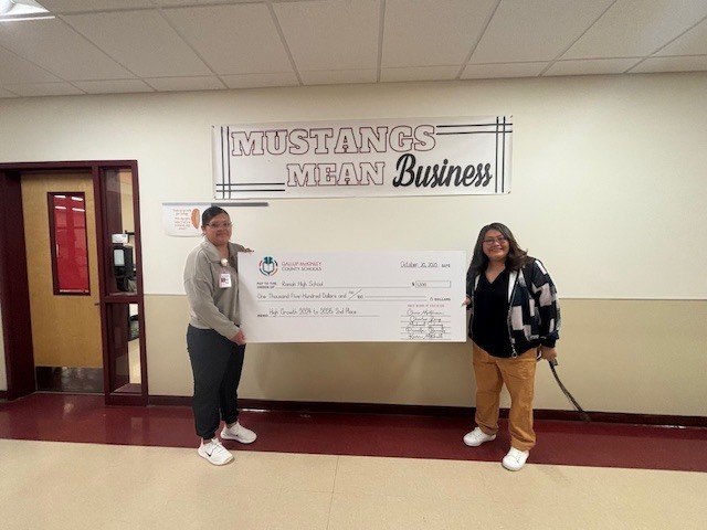 Ms. Panteah and Mrs. Martin holding the large check from the school district.