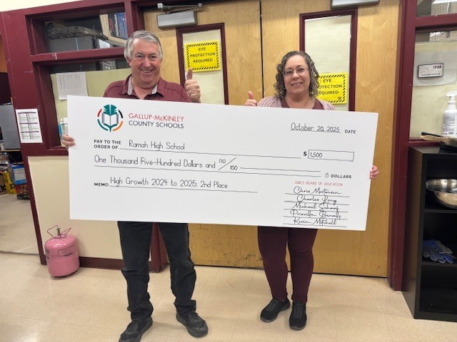 Mr. Noe and Ms. Clawson holding the large check from the school district.