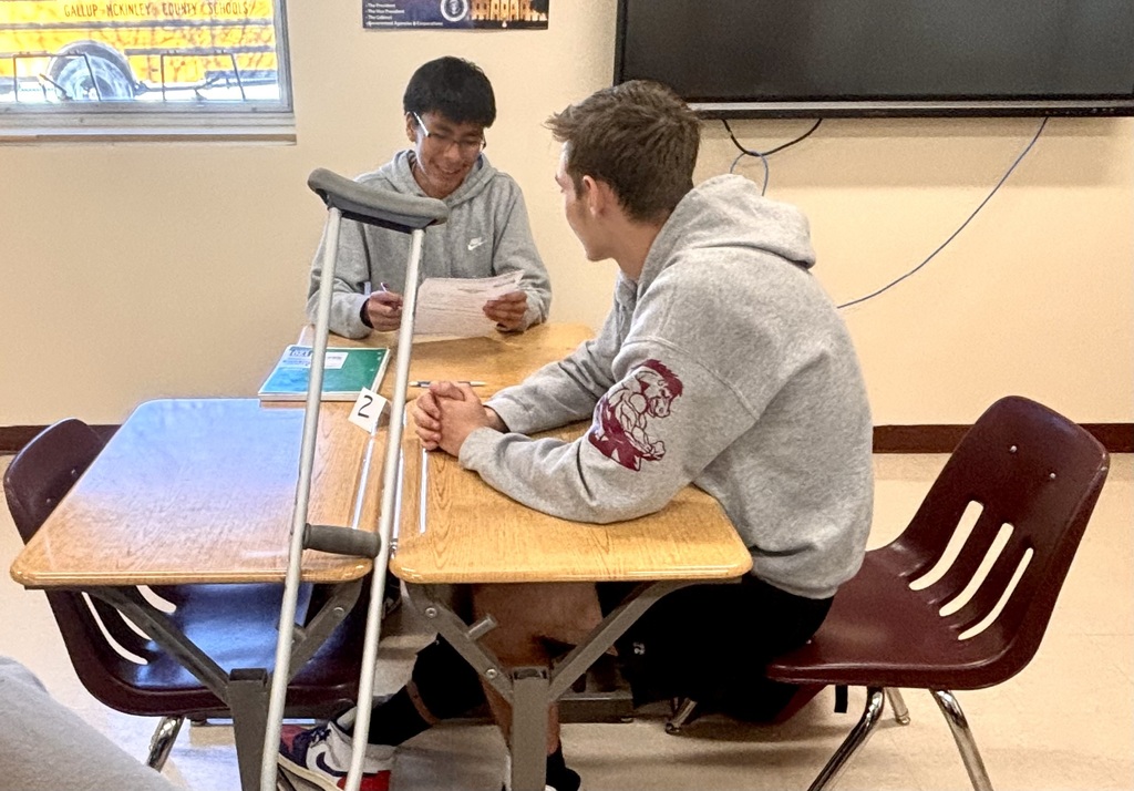 students discussing and working on bills