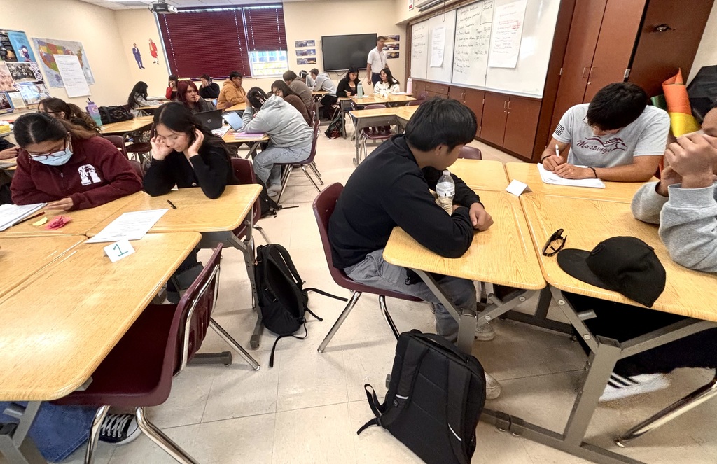 students discussing and working on bills