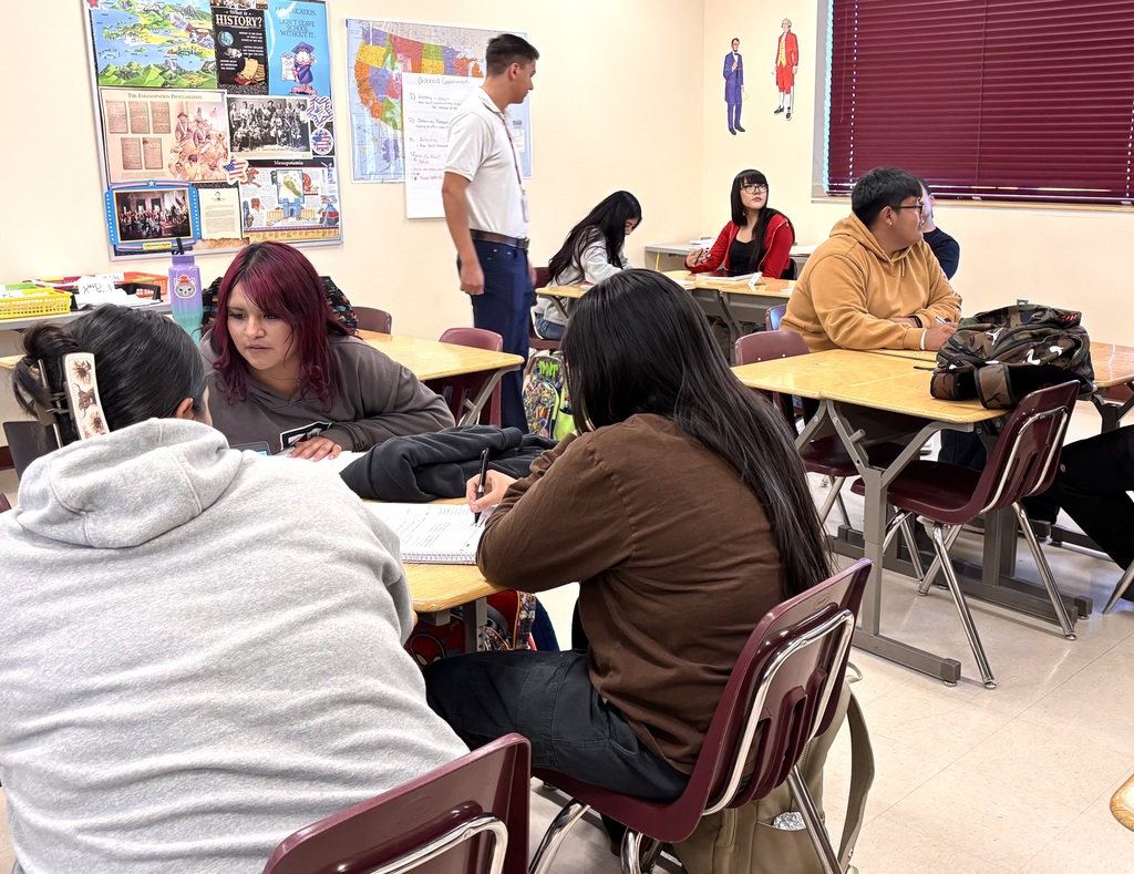 students discussing and working on bills