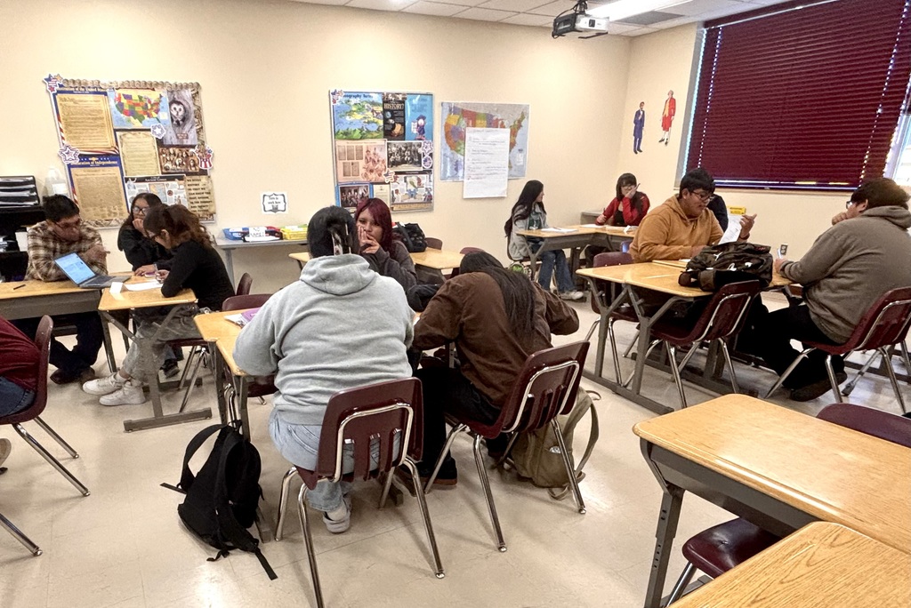 students discussing and working on bills