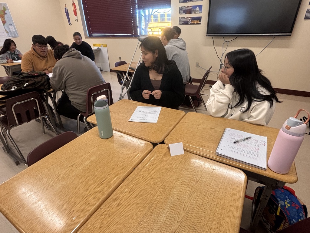 students discussing and working on bills