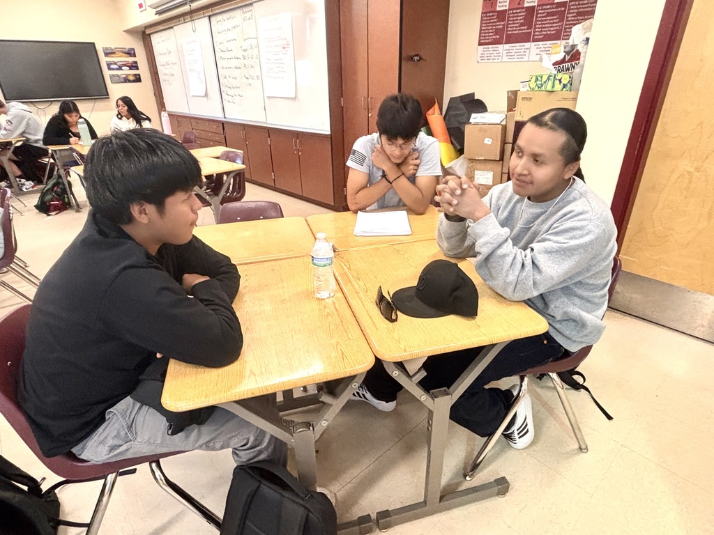 students discussing and working on bills