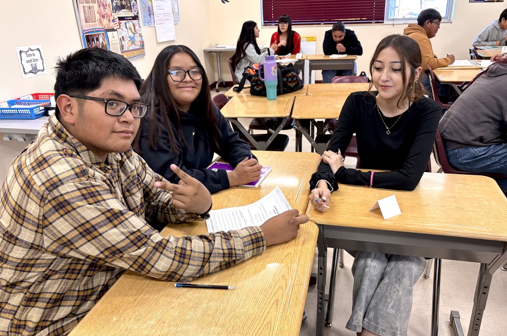 students discussing and working on bills