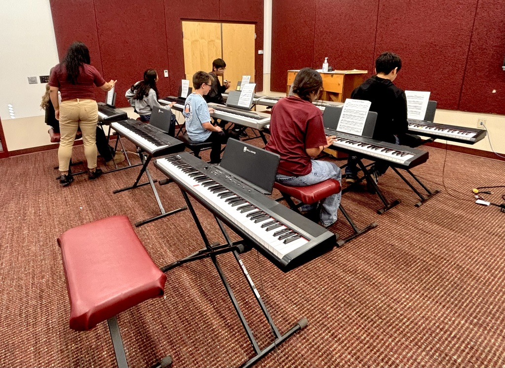 Students playing the electric pianos.