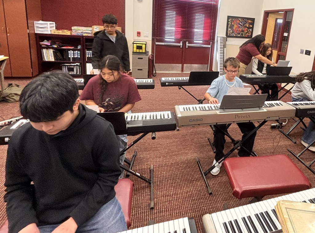 Students playing the electric pianos.