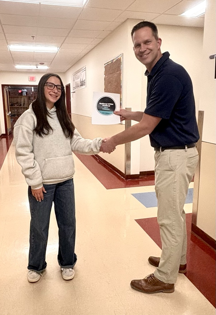 Principal Gibbons congratulating Marian