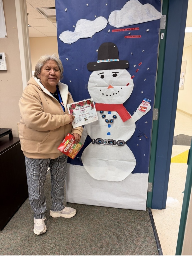 Ms. Tsosie with a traditional snowman wearing a belt and a hat.