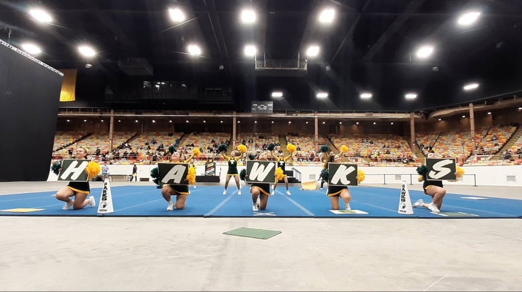cheer team, gym bleacher green and white uniforms 