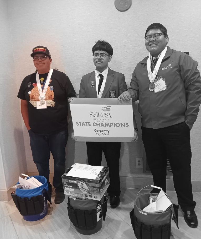 three high school students pose for a photo at the 60th Annual SkillsUSA New Mexico State Leadership and Skills Conference