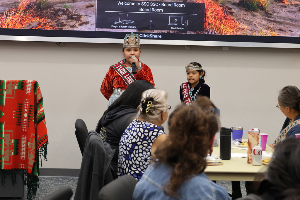 Two little girls present in front of another audience, one is princess twin lakes and the other is lil princess of twin lakes