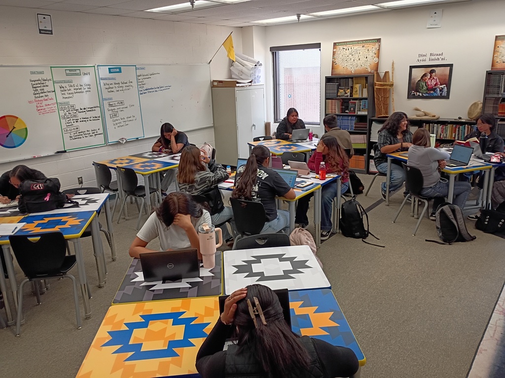 students desk , classroom, gray carpet. yellow, blue, black, and white desks