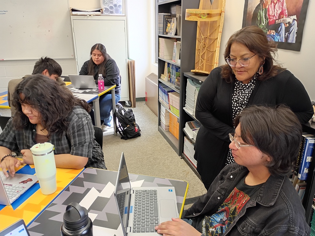 students desk , classroom, gray carpet. yellow, blue, black, and white desks