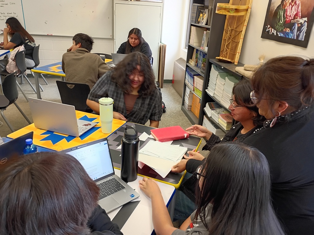 students desk , classroom, gray carpet. yellow, blue, black, and white desks