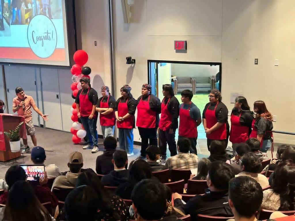 people in red aprons