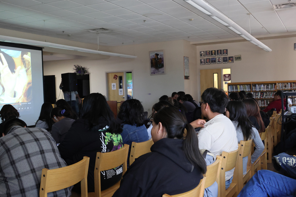 students sit in chairs