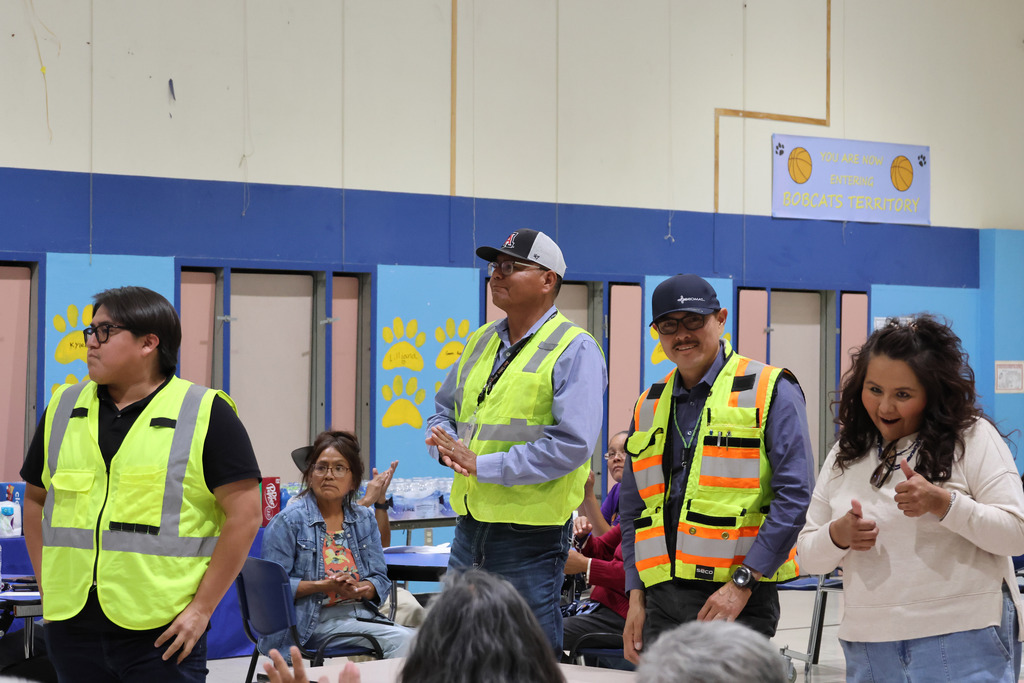 people in safety vests standing