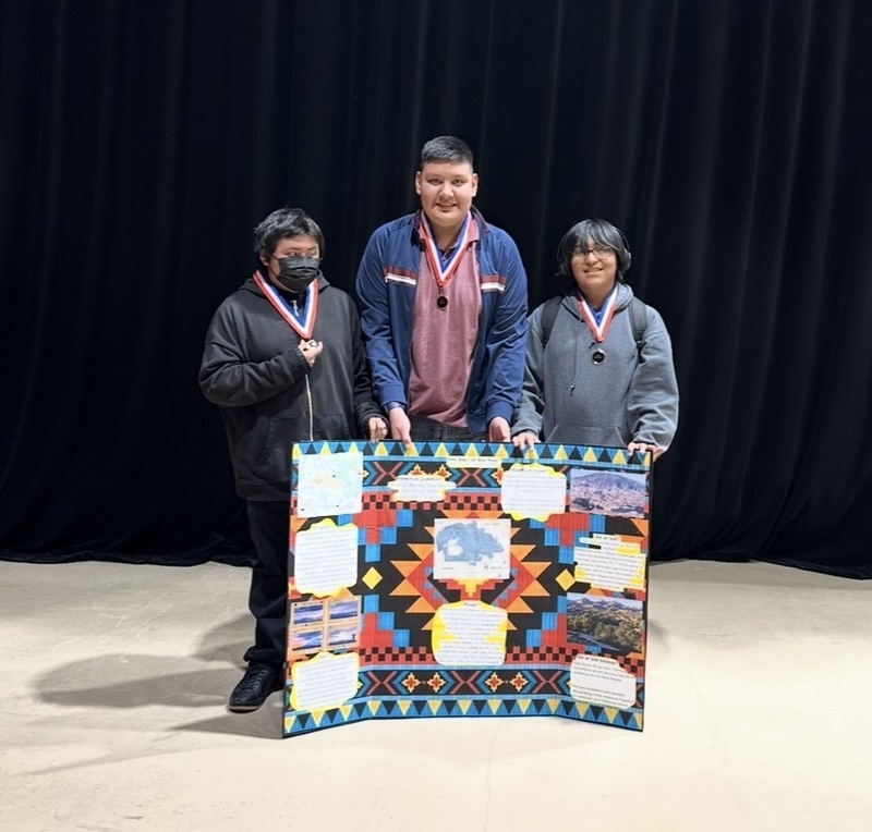 black background, students, trifold project