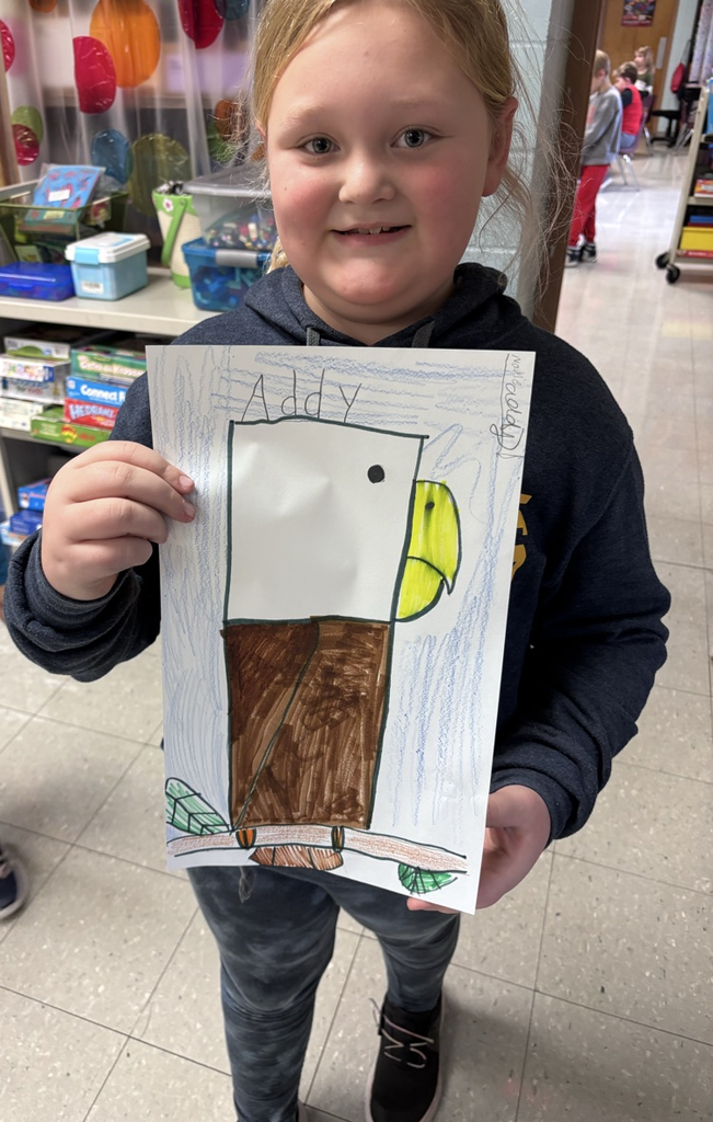 Child holding a picture of an eagle