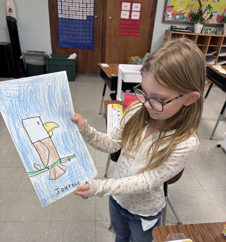 Child holding a picture of an eagle