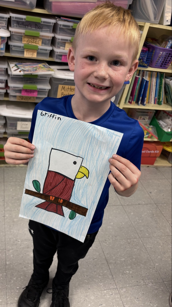 Child holding a picture of an eagle