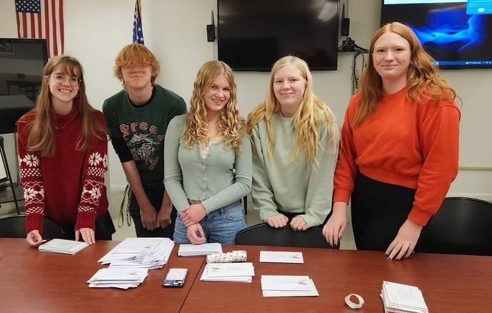 Interact students writing cards