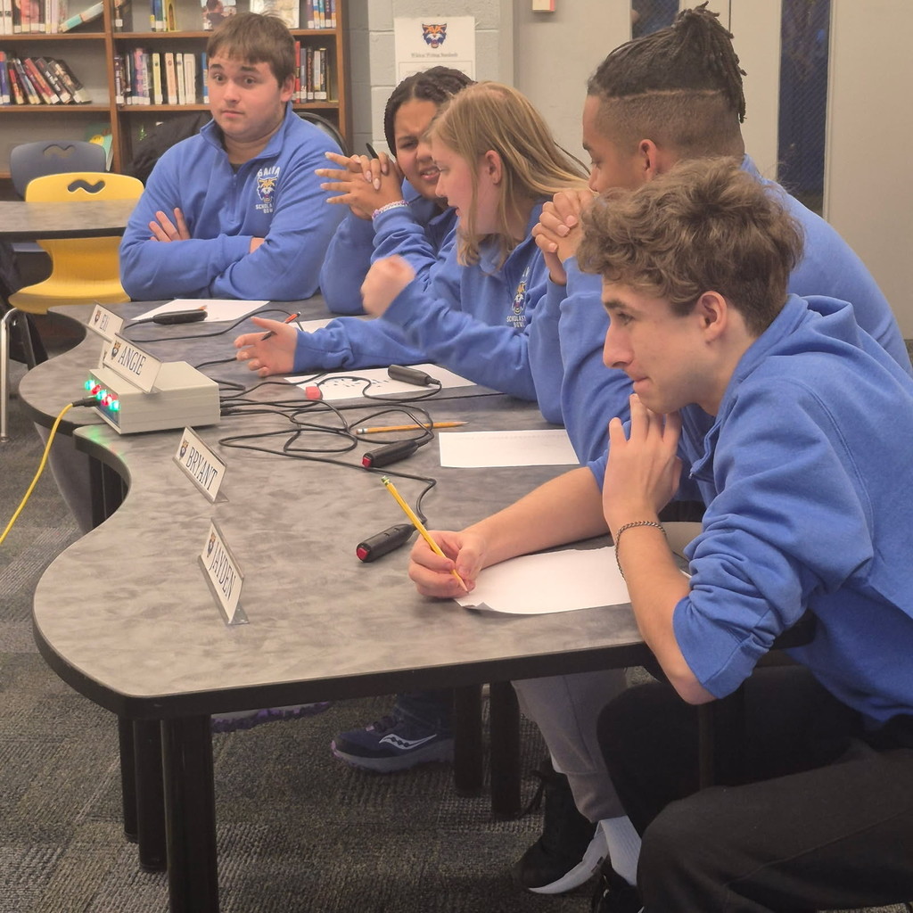 scholastic bowl students at a table with buzzers