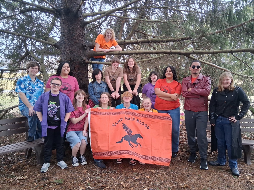 A photo of the cast of The Lightning Thief in front of and in a tree.