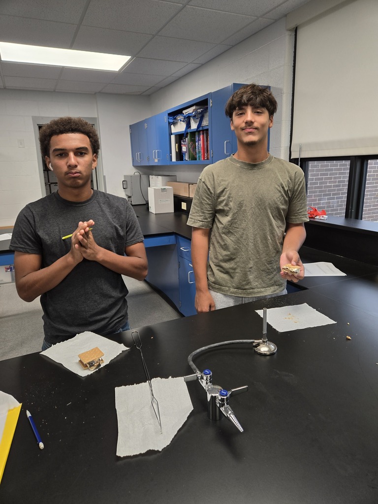 boys pose in lab with s'mores