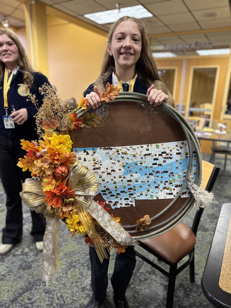 FFA member poses with handmade rope wreath that was part of the Floriculture contest.