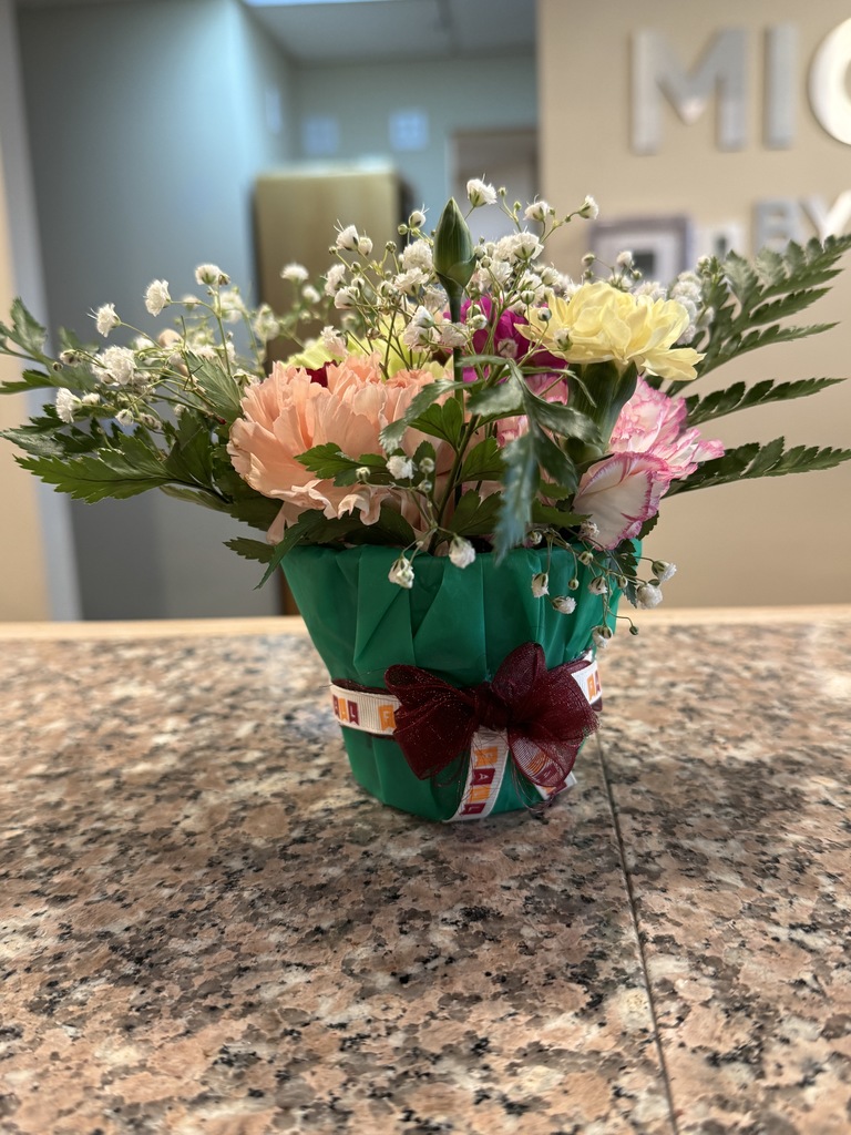 A small flower arrangement sits on a desk of a hotel. The flowers were arranged by an FFA member during the Floriculture competition.