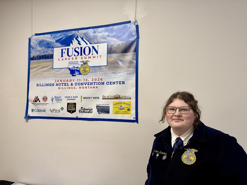FFA member named Summer stand in official dress in front of the Fusion Career Summit banner.