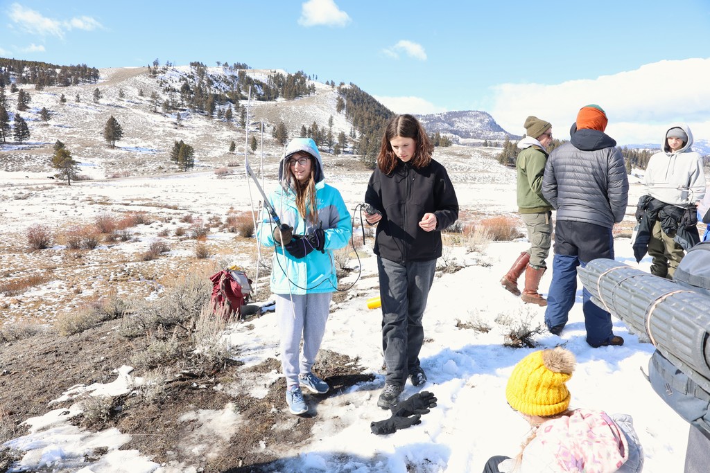 Students learning how to use telemetery  to detect collared animals.
