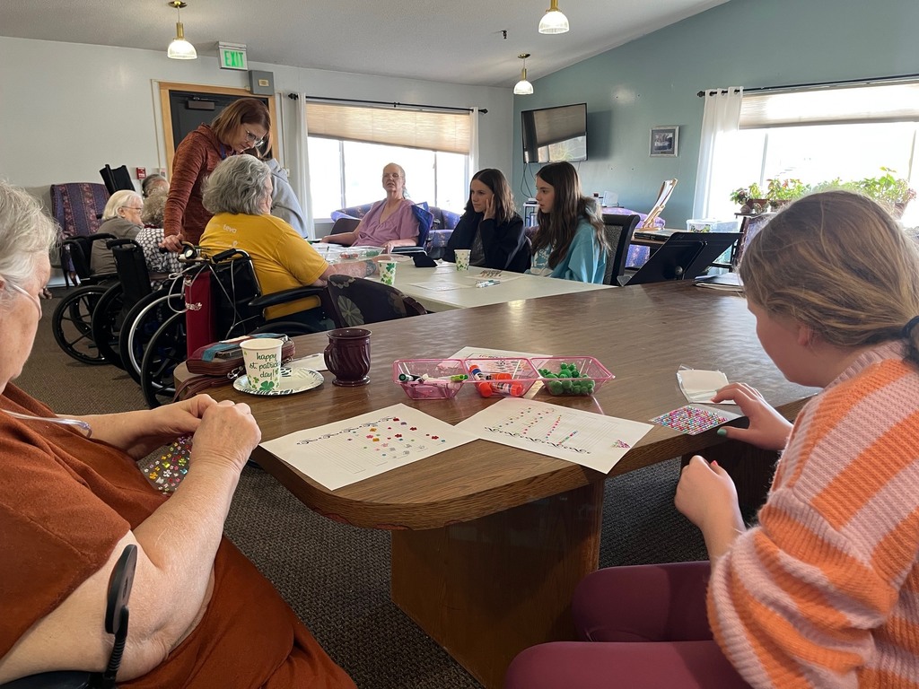 7th grader, Reagan, crafting with resident.