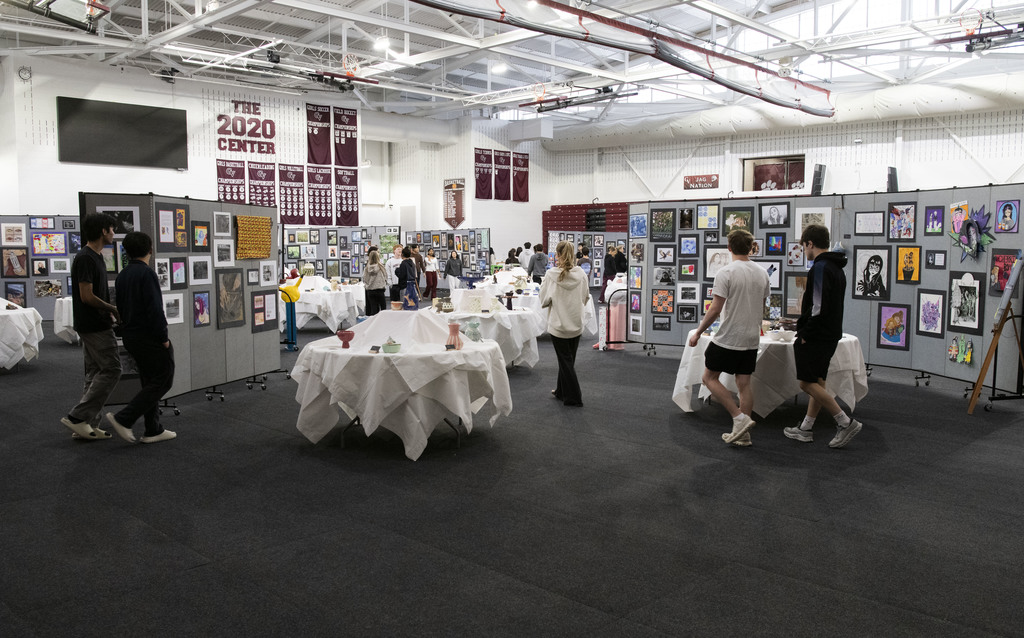 Group of students looking at artwork on display in the GVHS gym