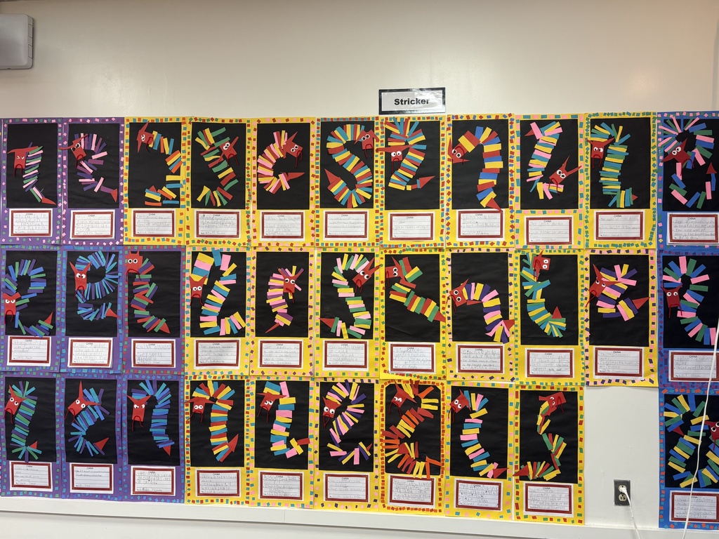 Artwork on the wall depicting the Chinese dragon using colorful pieces of paper.