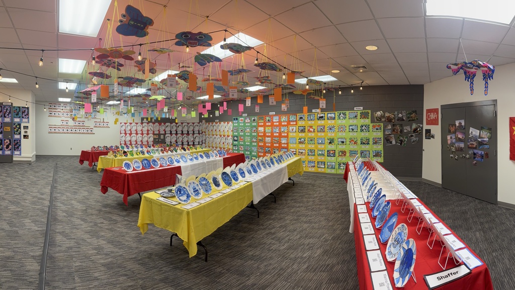 Another view of all the artwork on tables, wall, and ceiling.