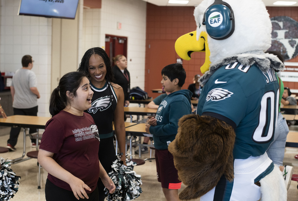 Student excited to see Swoop while cheerleader smiles